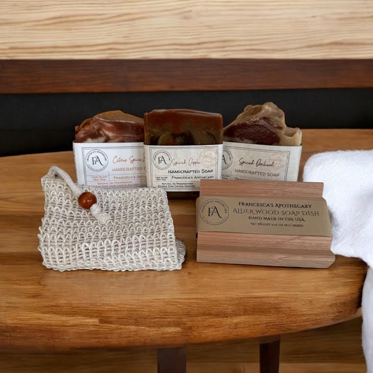 Luxurious Spicy Fruit Soap gift set on a wooden table, featuring elegantly packaged soaps in a white box adorned with branded elements.