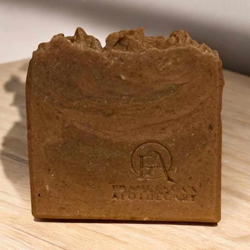 Cozy Pumpkin Bread Soap with creamy pumpkin and vanilla aroma, on a wooden surface.