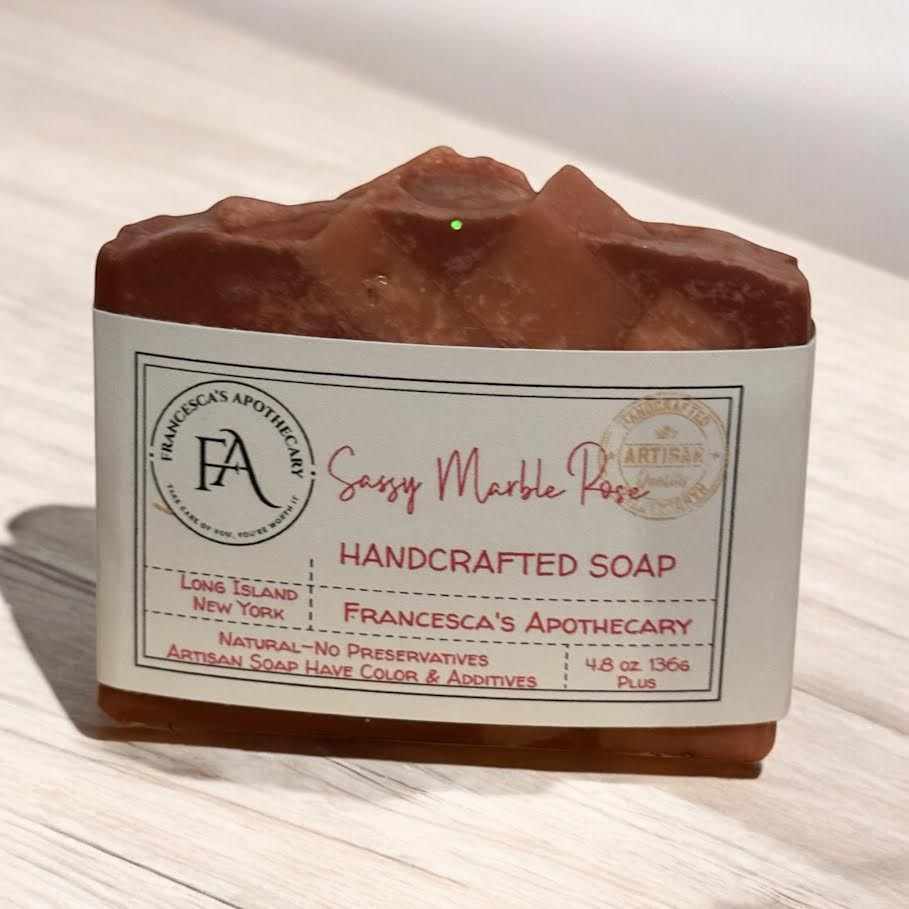 Sassy Marble Rose Soap with rose fragrance and marbled design on a wooden surface.