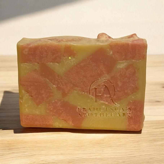 Lemon Marble Rose Soap with zesty lemon and rose aroma, wooden background.