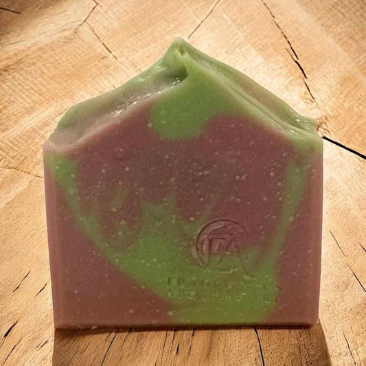 Serene Mist Soap with natural ingredients and floral aroma on wooden surface.