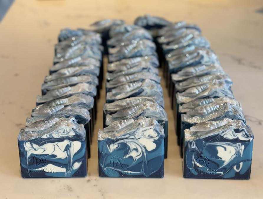Custom wedding shower favor soap with spearmint and eucalyptus fragrance, featuring blue and white swirls, topped with a shell design, mica, and biodegradable glitter.