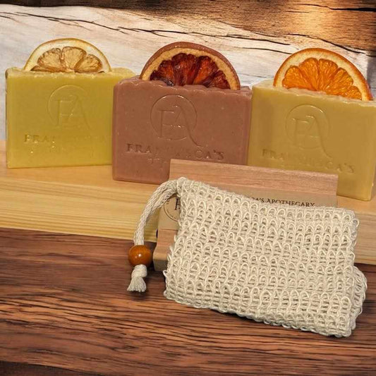 Natural fruit bundle with lemon, grapefruit, and orange blossom soaps displayed on wooden background, includes crochet soap pouch.
