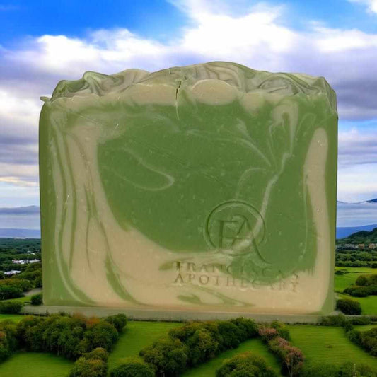 Emerald Mist Soap with French verbena, lemon, sandalwood, and ambergris on Irish landscape background.