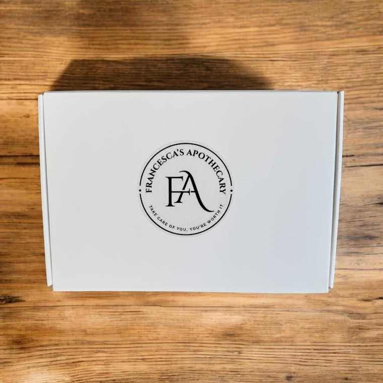 Luxurious white gift box with brand logo, featuring earthy woody amber soap collection.