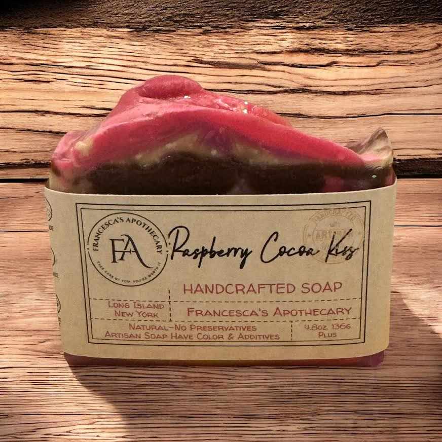 Raspberry Cocoa Kiss soap with fruity and floral notes, handcrafted and wrapped in a rustic label.