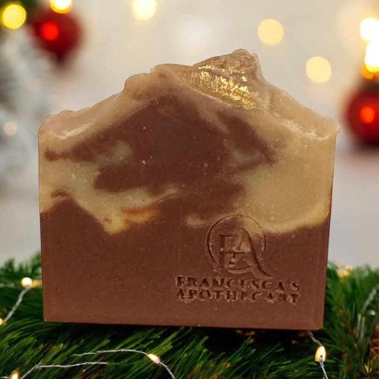 Luxurious spicy fruit soap adorned with festive decor, featuring a blend of citrus and warm spices in an elegant gift box.