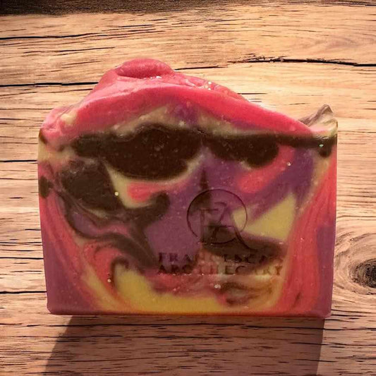 Raspberry Cocoa Kiss Soap with vibrant swirls of pink, purple, and chocolate brown.
