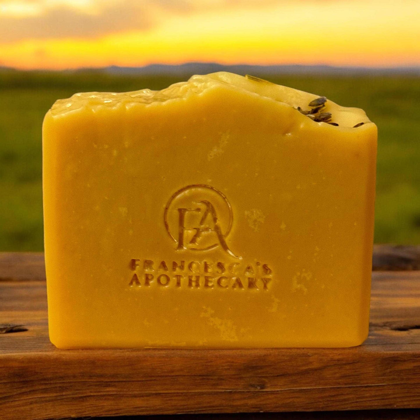 Goat Milk & Honey Lavender Soap on wooden surface at sunset.