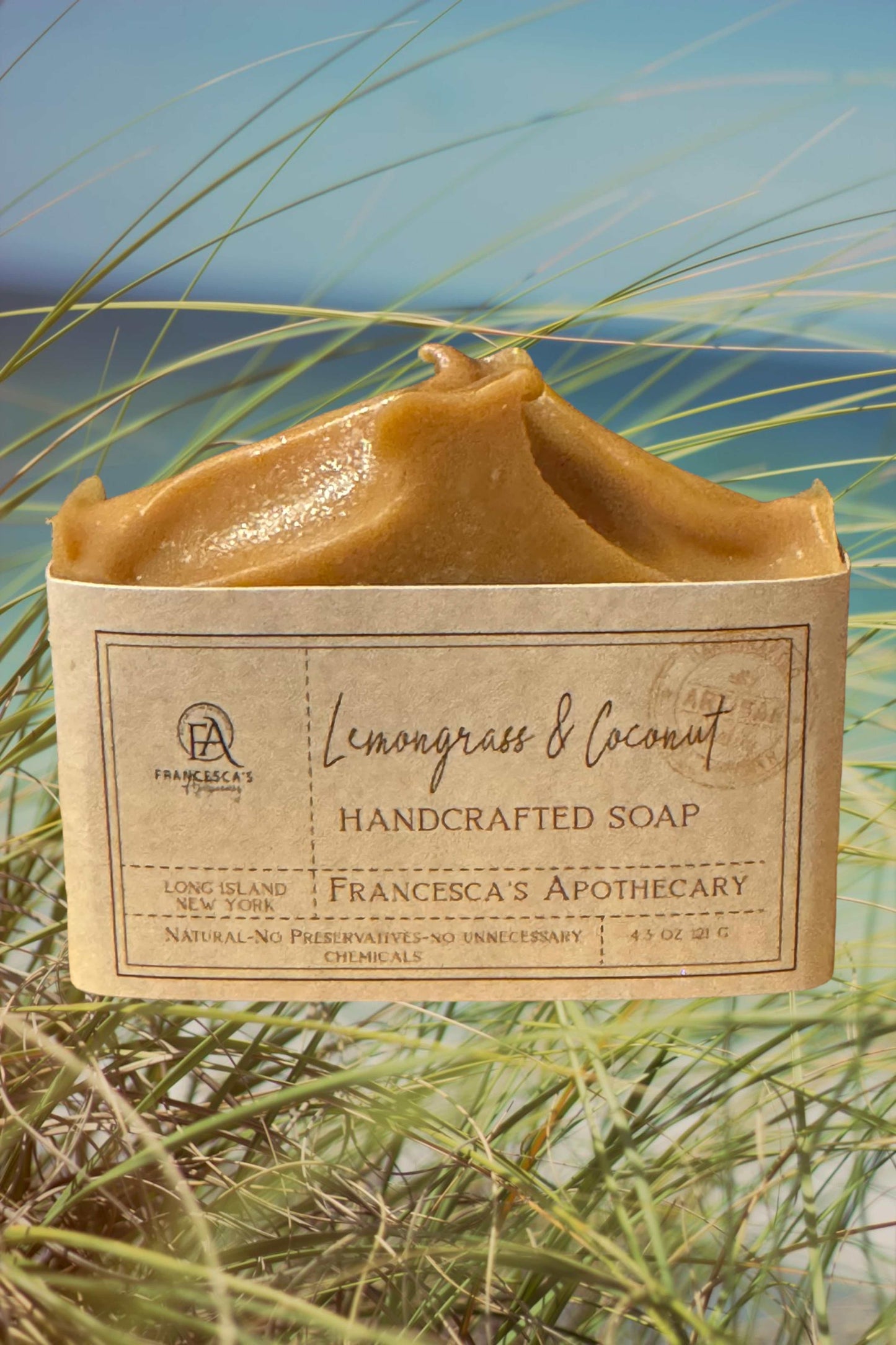 Handcrafted lemongrass and coconut soap bar with natural ingredients outdoors.