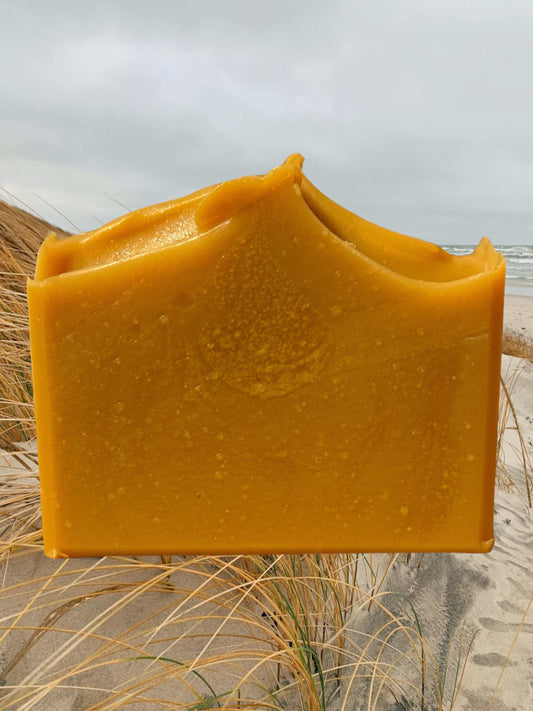 Handcrafted Lemongrass & Coconut Soap with Kaolin Clay on Beach Background