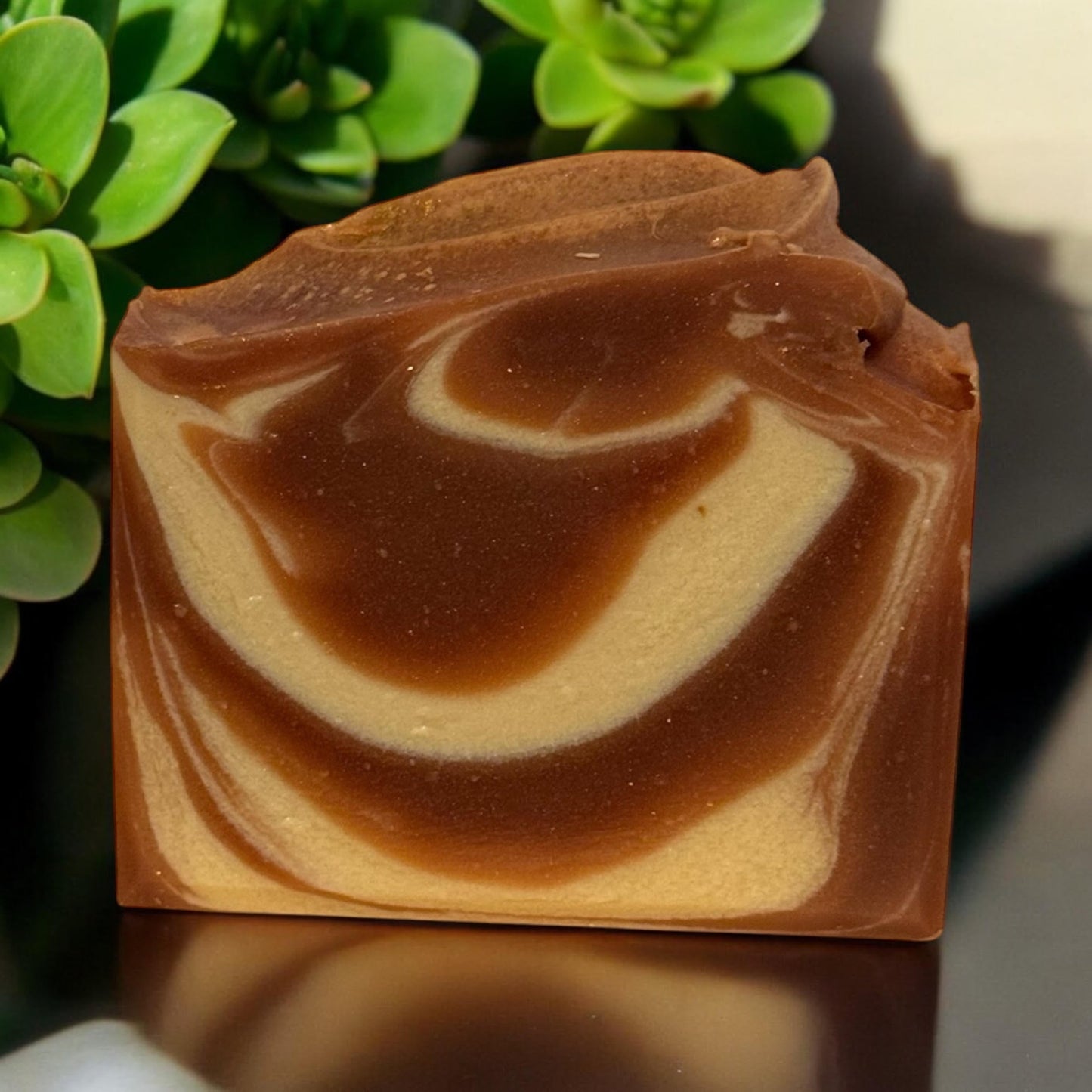 Luxurious spicy fruit soap with swirled brown and cream design, perfect for gifting in an elegant white box.