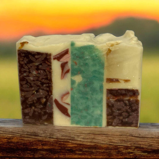Mosaic style soap with vibrant colors and natural ingredients on a rustic background.