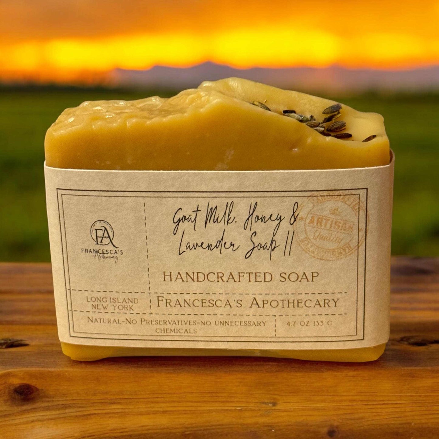 Handcrafted Goat Milk, Honey & Lavender Soap on a wooden surface at sunset.