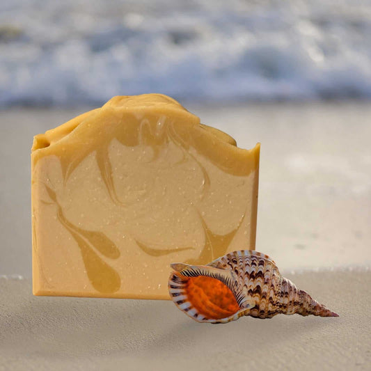 Coconut Bay Soap with fresh coconut aroma on sandy beach background.
