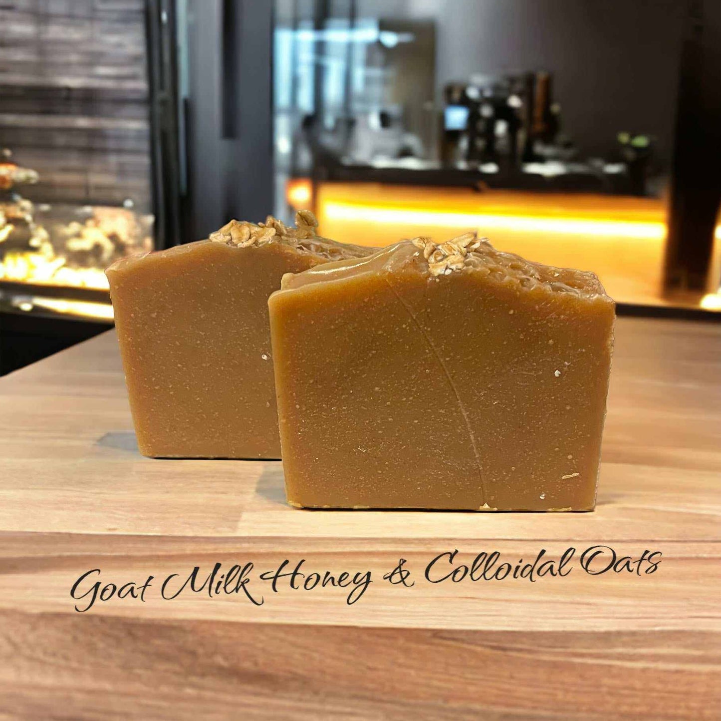 Goat Milk Honey and Colloidal Oats soap bar with nourishing ingredients on a wooden surface.