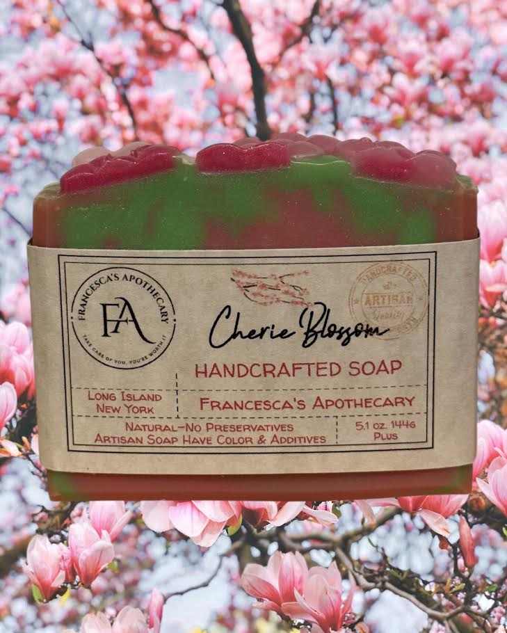Handcrafted floral fruity summer scent soap with cherry blossom background.