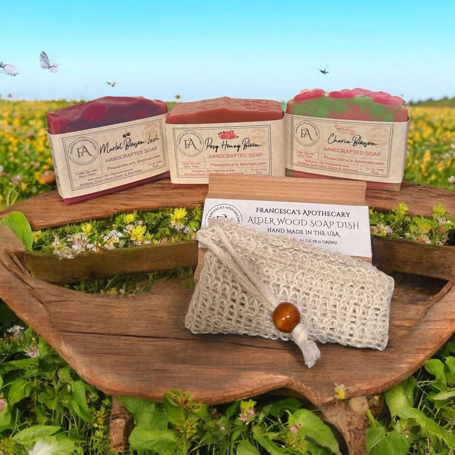 Floral Fruity Summer Scent Soap Lux Box Bundle with Merlot Blossom, Rosy Honey, and Cherie Bloom soaps, displayed outdoors with a handcrafted soap dish.